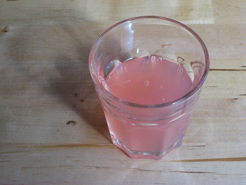 The rosy apple juice byproduct of steaming unpeeled apples for apple sauce.